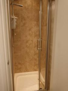 a shower with a glass door in a bathroom at London Collection - Bayswater in London
