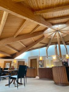 a large room with wooden ceilings and tables and chairs at Pension Sassnitz Atelierhaus in Sassnitz