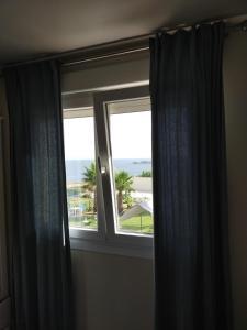 a window with a view of the ocean at Punta Carnero Hostal singular in Algeciras