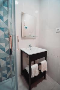 a bathroom with a sink and a shower at Harbour49 - AVEIRO FLATS & SUITES in Aveiro