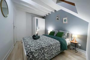 - une chambre avec un lit king-size et des oreillers verts dans l'établissement Appart'Hôtel BELLE HELENE Calme & Chic, à Montereau-faut-Yonne