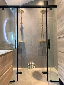 a shower with a glass door in a bathroom at Nesje Gardstun in Oppstryn +38 photos