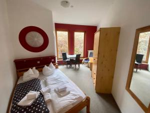 a bedroom with a bed and a table and chairs at Pension Sassnitz Atelierhaus in Sassnitz