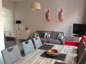 a living room with a table and chairs and a couch at Holiday Home 't Beertje in Bruges