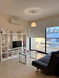 a living room with a couch and a tv at Albert's apartment Centre 601 in Larnaca