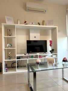 a living room with a tv and a glass table at Albert's apartment Centre 601 in Larnaca