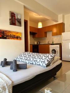 a kitchen with a bed with a zebra blanket on it at Albert's apartment Centre 601 in Larnaca