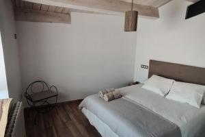 a bedroom with a large bed and a table at La Cartería de Trabanca in Trabanca