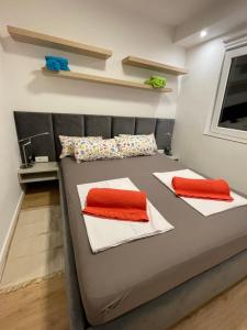 a bed in a room with two pillows on it at Artatore24 - Modern and stylish Apartments in Mali Lošinj