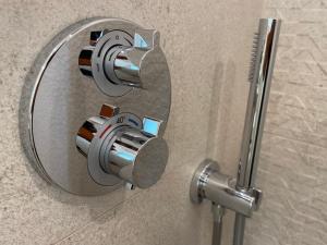 a metal shower knob on a wall in a bathroom at Artatore24 - Modern and stylish Apartments in Mali Lošinj +77 photos