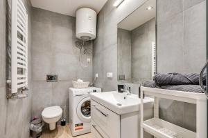 a bathroom with a sink and a washing machine at Central Platinum Apartments 30 Studio z aneksem kuchennym in Rybnik +16 photos