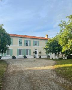 a large house with a gravel driveway in front of it at Les Grands Vents in Chervettes