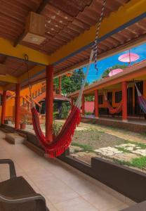 a porch with hammocks hanging from a building at Hostal Familiar Rolo in Santa Catalina
