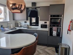 a kitchen with a table and a counter top at Holiday Apartment Beverley in Beverley