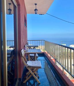patio con mesa y sillas en el balcón en Naomi’s House, en Fasnia