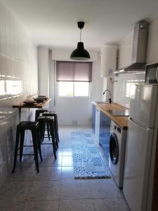 cocina con lavadora, mesa y sillas en DEVATRIZ, en Unquera