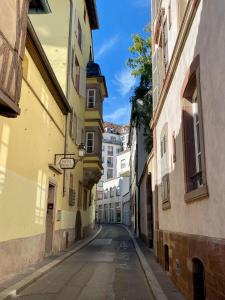 an empty street in a city with buildings at Hôtel Patricia - Strasbourg Hyper Centre in Strasbourg