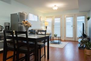 a kitchen and dining room with a table and chairs at Lovely 1BR Secondary suite with Separate entrance in New Westminster +16 photos