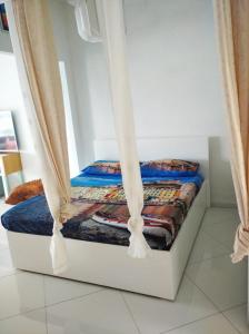 a bed in a room with curtains around it at appartamento openspace fronte mare esclusivo due letti matrimoniali a Portovenere in Portovenere