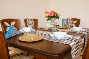 a wooden table with plates and bowls on it at Krichim Apartments,Three-Bedroom, large apartment, TOP CENTER in Sofia