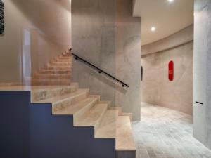 a staircase in a building with a red fire extinguisher at Le Residenze by Victoria Palace in Cattolica