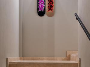 two skateboards hanging on a wall next to a staircase at Le Residenze by Victoria Palace in Cattolica