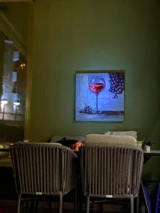 two chairs in a room with a picture of a wine glass at Sole in Makarska