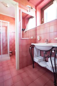 a pink bathroom with a sink and a mirror at Residence Criro in Marina Palmense +46 photos