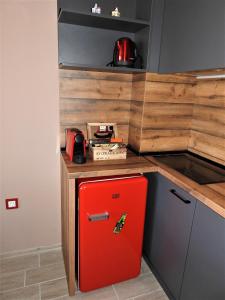 a red refrigerator in a kitchen with a counter at Vintage Studio Mladost in Sofia