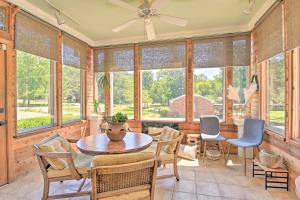a dining room with a table and chairs and windows at Spacious Nashville Retreat about 6 Miles to Broadway! in Nashville