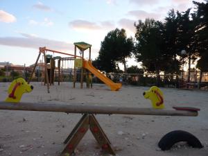 a park with a playground with a slide at Capo Scalambri in Santa Croce Camerina