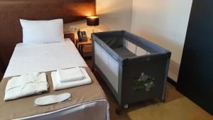 Ένα ή περισσότερα κρεβάτια σε δωμάτιο στο CAROUSEL HOTEL