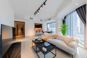 a living room with a couch and a table at EDEN'S Homes & Villas - Opera Grand in Dubai