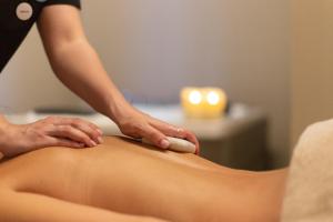 a woman getting a massage from a therapist at Octant Ponta Delgada in Ponta Delgada
