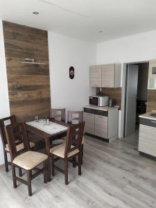 a kitchen with a table and chairs in a kitchen at Dom Stefany in Spišské Podhradie