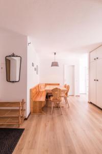 a dining room with a wooden table and chairs at Ferienwohnung Cristallina in Laax