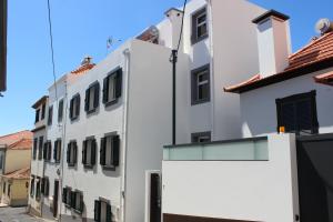a white building with a window on the side at Apartments Madeira Old Town in Funchal