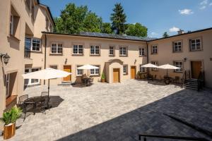 a courtyard with tables and chairs and umbrellas at Central Platinum Apartments 25 in Rybnik
