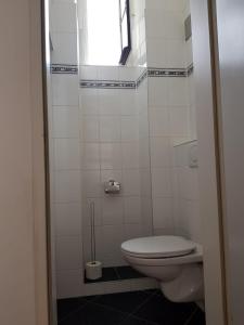 a small bathroom with a toilet and a window at Apartment Dahlia Vienna in Vienna