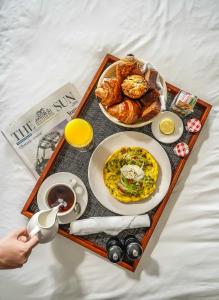 a tray of food with a breakfast of eggs and bread at Sagamore Pendry Baltimore in Baltimore