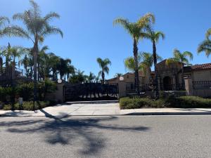 a street with palm trees in front of a house at LuxHome Suites & Villa in Riverside