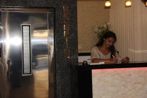 a woman sitting at a counter in a restaurant at Era Palace Hotel in Istanbul