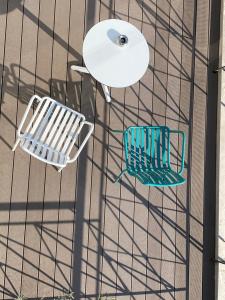 an overhead view of a chair and a table at Evripides Hotel in Athens