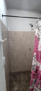 a shower with a shower curtain in a bathroom at Cabaña Salguero in Santa Marta