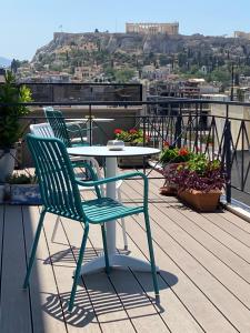a table and chairs sitting on a balcony at Evripides Hotel in Athens