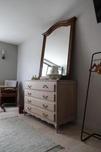a dresser with a mirror on top of it at NeNe in Dilbeek
