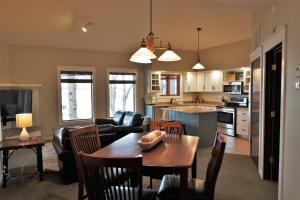 a kitchen and living room with a table and chairs at Lakefront Gull Lake 2BR Condo Boat Rentals Available Bay Colony 773 in Nisswa