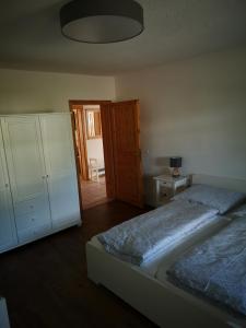a bedroom with a bed and a dresser and a bedroom with a bedskirts at Ferienwohnung Gerda in Groß Stresow