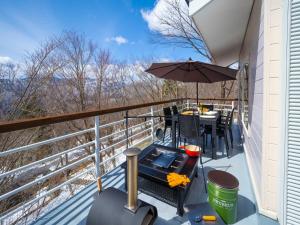 a balcony with a table and an umbrella at Baberu - Vacation STAY 13021 in Nasushiobara