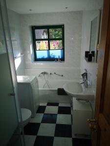 a bathroom with a sink and a tub and a toilet at Ferienwohnung Gerda in Groß Stresow